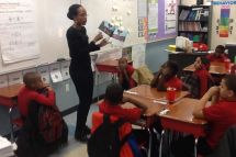 A teacher reading Penny and the magic puffballs to her class